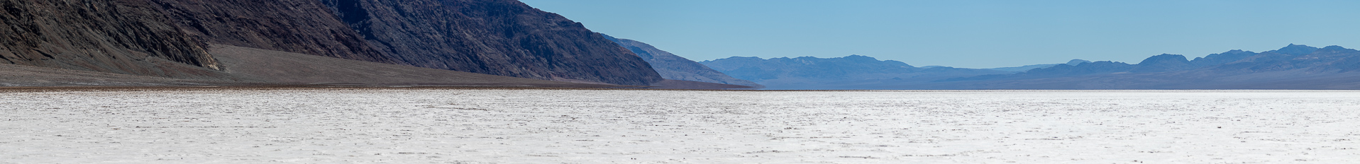 Death Valley landscape — volcanic cinder cones and alluvial fans spread across the valley floor